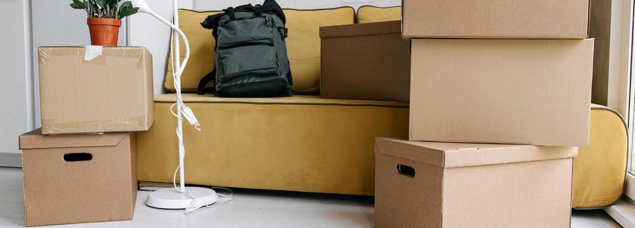 A living room with moving boxes representing the legal changes to a relationship after moving in together in Ontario