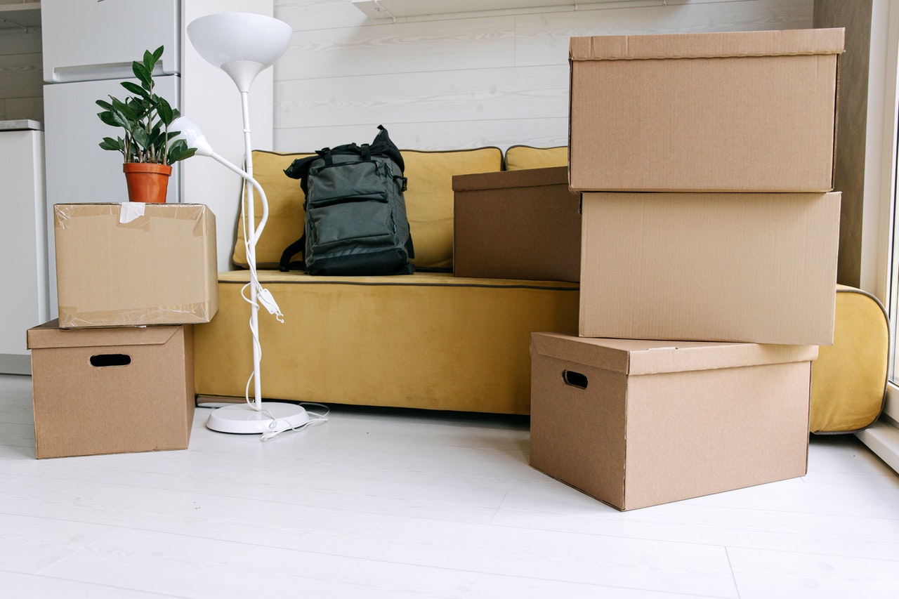 A living room with moving boxes representing the legal changes to a relationship after moving in together in Ontario